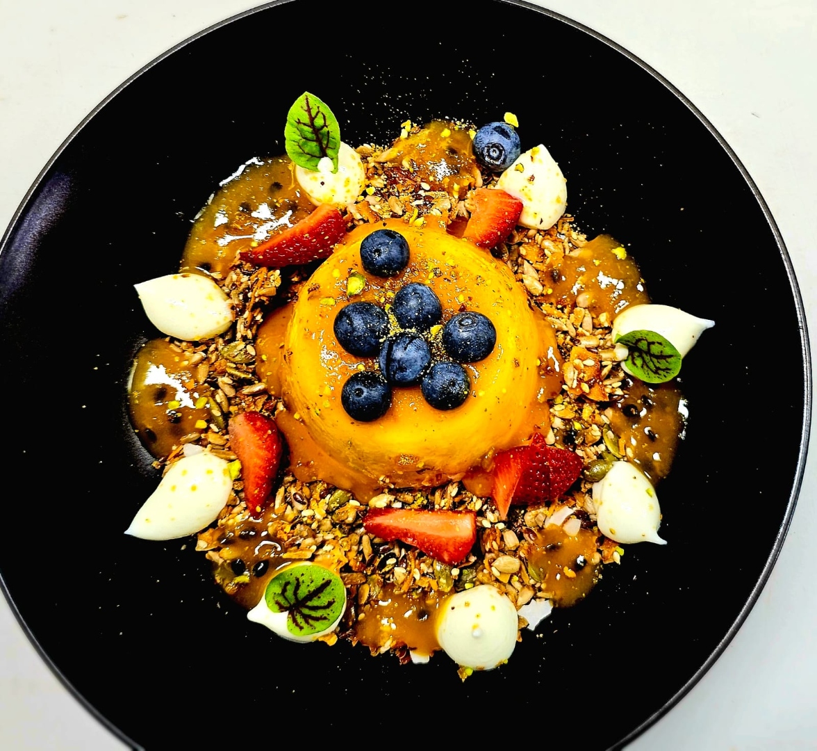 Creamy coconut milk porridge with red wine glazed pear and nut granola
