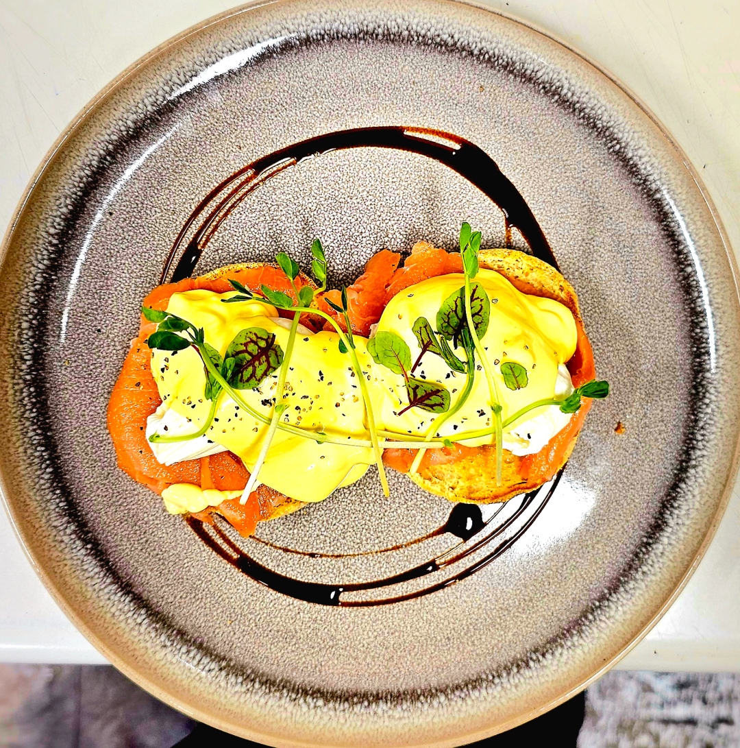 Smoked salmon eggs benedict with hollandaise and microgreens