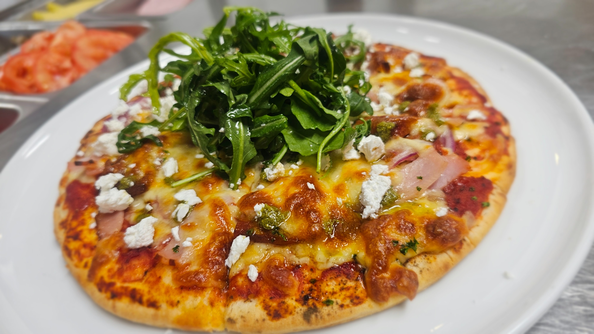 Flatbread pizza with chorizo, bacon and fresh rocket