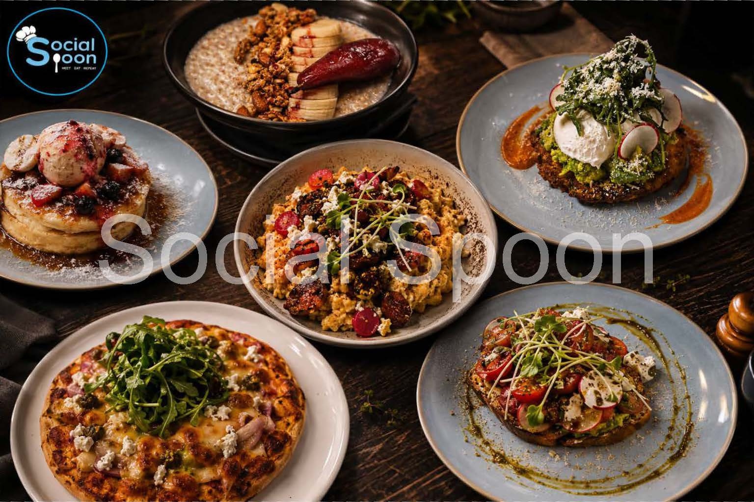 Spread of Social Spoon dishes including pancakes, smashed avo and scrambled eggs